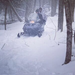 snowmobiling in the winter woods